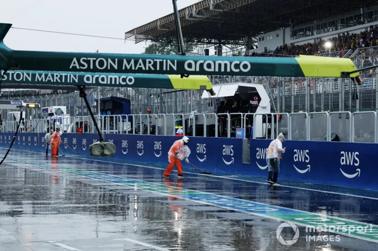 Flooded Interlagos race track with marshals sweeping away standing water during the November 2024 São Paulo Grand Prix