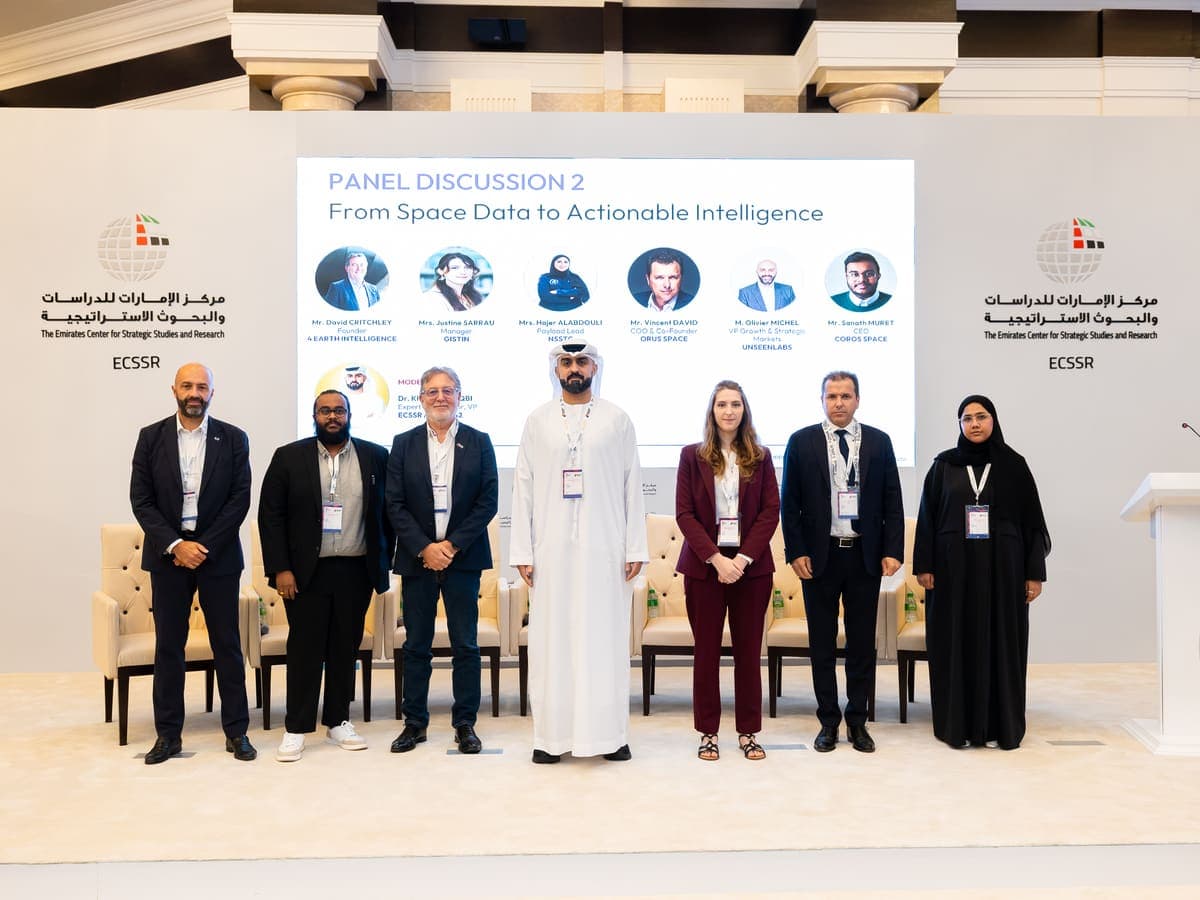 Group photo of the panel speakers and moderator in front of the ECSSR stage