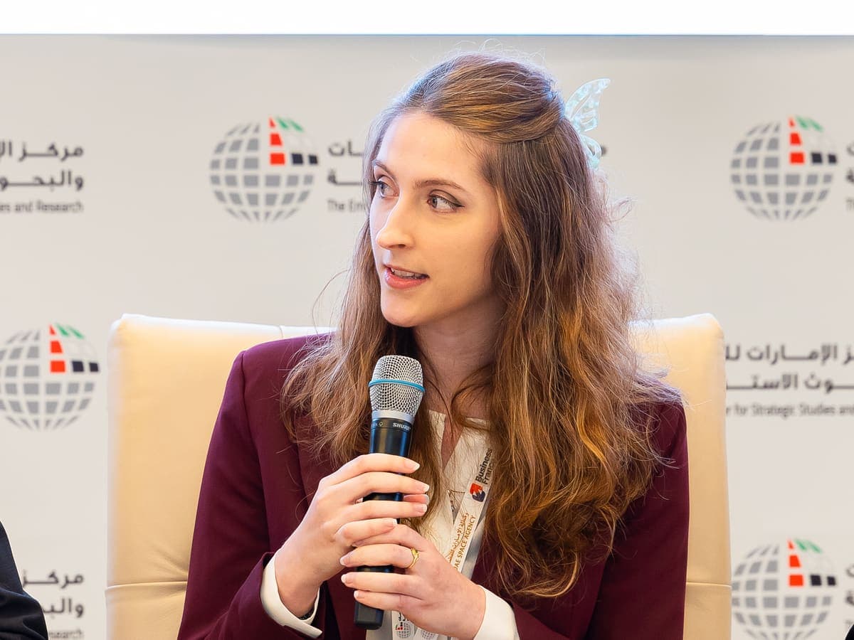 Dr. Justine Sarrau answering the moderator's question, microphone in hand