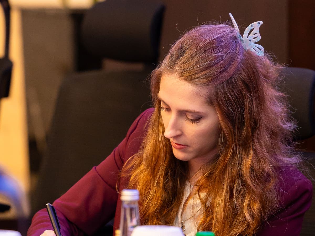 Dr. Justine Sarrau taking notes during the institutional sessions